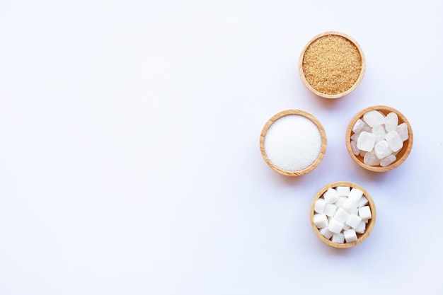 Various types of sugar on white background.