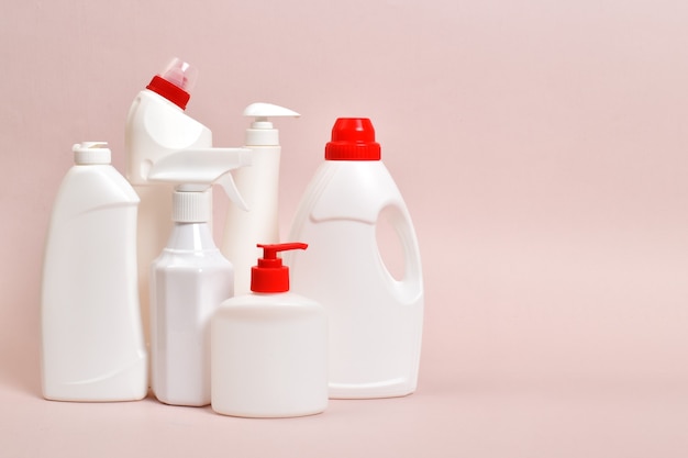 Various white plastic bottles of detergent with a place for text. Everything for cleaning. Disinfection of the house, office, apartment.