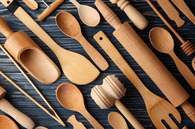 Various wooden kitchen utensils on table