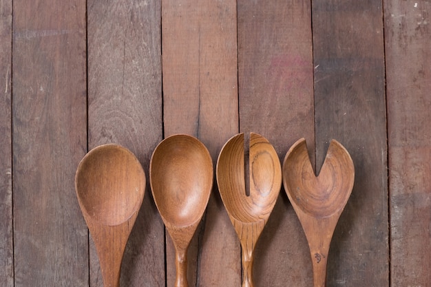 Various wooden spoons of wooden background 