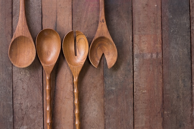 Various wooden spoons of wooden background 