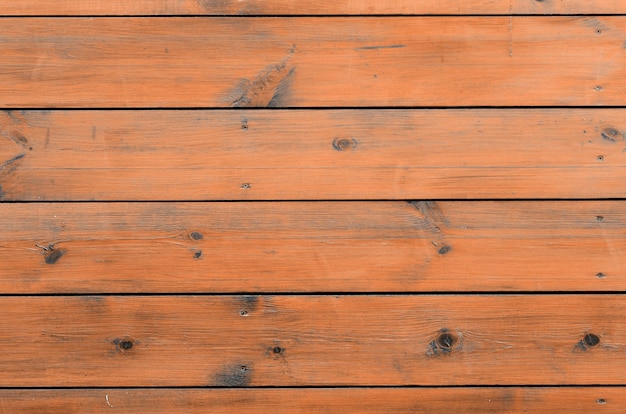 Varnished wood background from cabin exterior. Brown wood barn plank