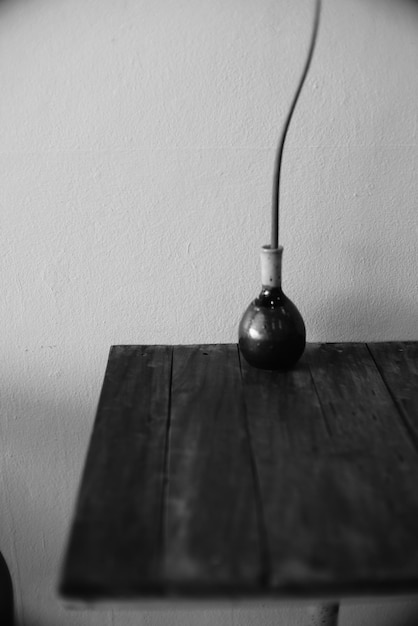 Photo vase on table against wall