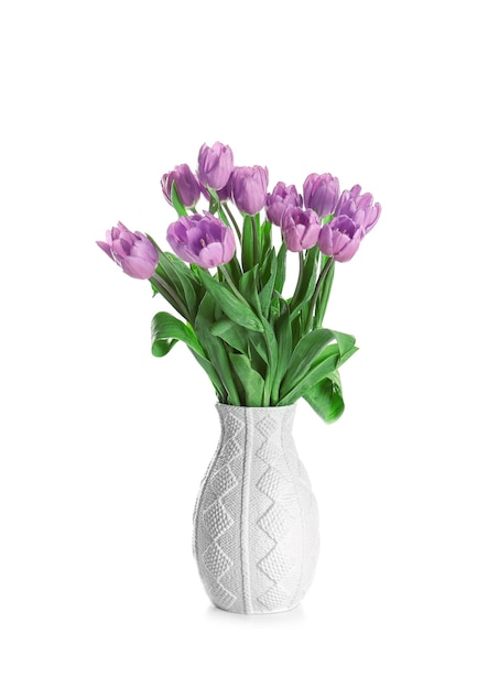 Vase with beautiful bouquet of lilac tulips on white background