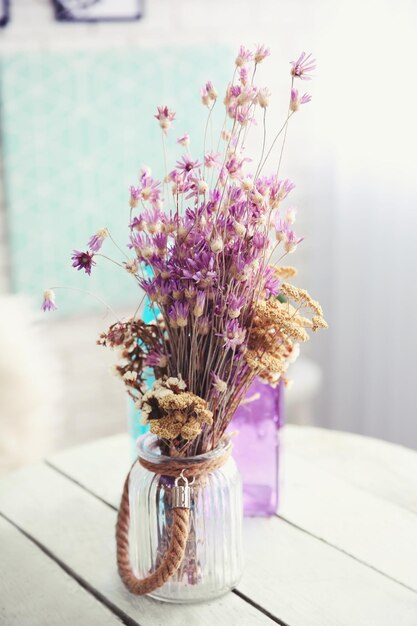 Vase with flowers on tableon light background Modern room interior concept