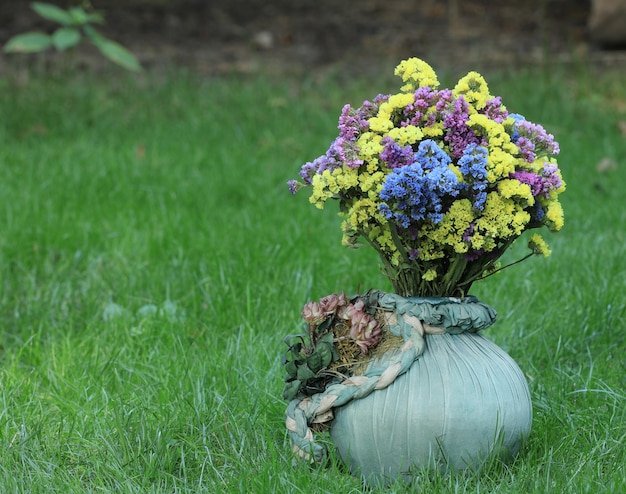 vase with wild flowers on the lawn