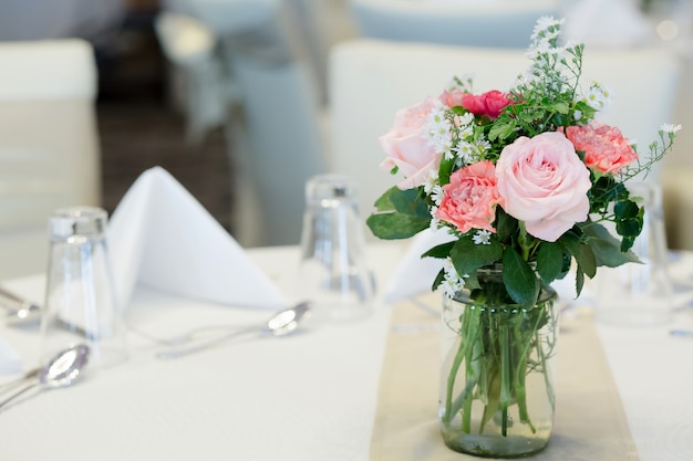 Vases rose on the tableware.