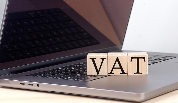 VAT word on wooden block on laptop business concept