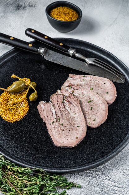 Veal or beef boiled tongue slices on a plate