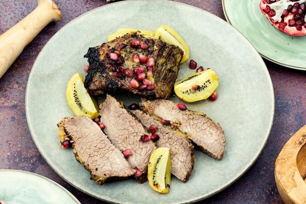 Veal meat roasted with kiwi and pomegranate