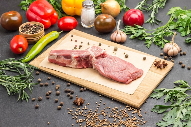 Veal meat with bone on cutting board