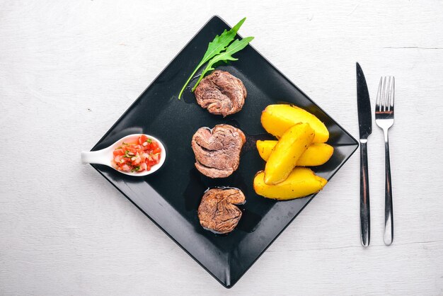 Veal medallions on a wooden background Top view Free space for text