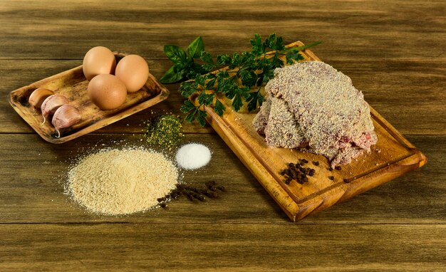 Veal milanese presented on the table with ingredients