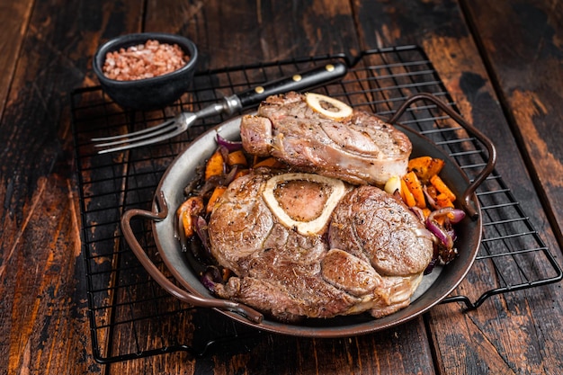 Veal shank stew Osso Buco italian ossobuco meat steak Wooden background Top view