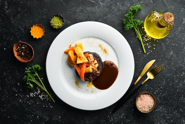 Veal steak baked with vegetables on a plate Restaurant menu European cuisine