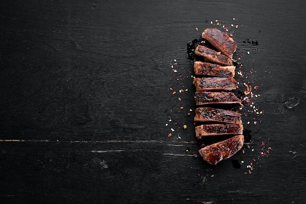 Veal steak On a wooden background Top view Free space for your text