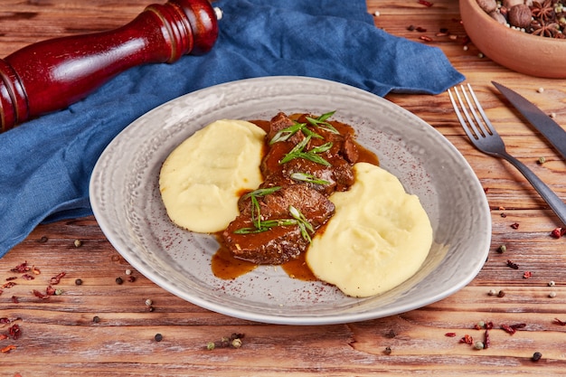 Veal stewed in beer, russian cuisine, wooden