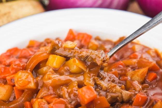 Photo veal stewed with vegetables in tomato sauce