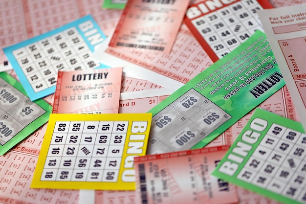 Veel gebruikte loterijbiljetten met nummers en bingo-speelborden in grote stapels Gokken en loterijpapieren