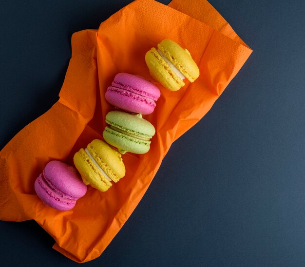 Veelkleurige macarons op een oranje servet