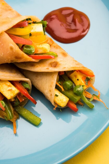 Veg Spring Roll OR Wrap OR Franky, made using Paneer and Vegetables stuffed inside Chapati or Roti. Served with Tomato Ketchup. Selective focus