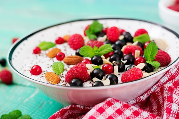 Vegan almond milk chia seeds pudding with raspberries, blackberries and mint.