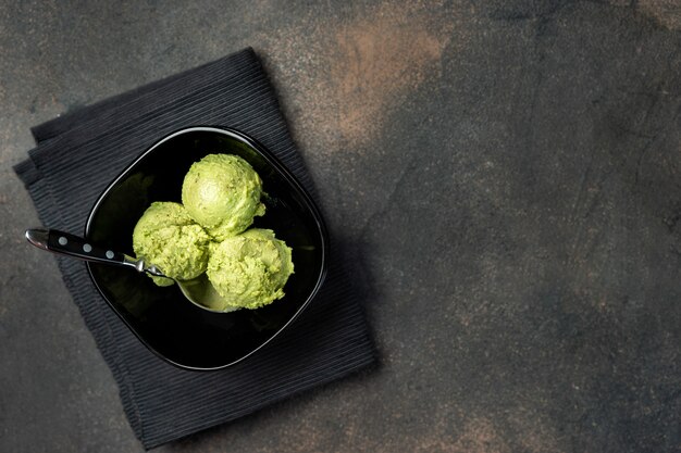 Vegan avocado ice cream in black bowl from above