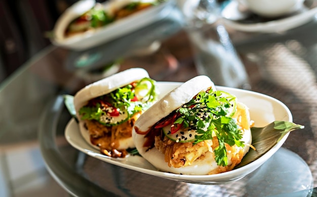 Vegan bao sandwich with tofu and kimchee in a cafe