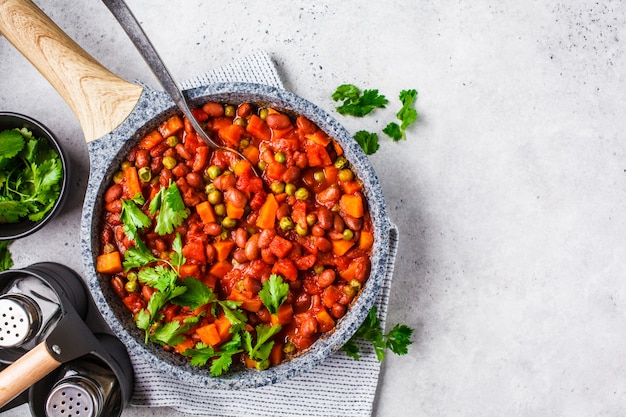 Vegan bean stew with tomatoes in a pan