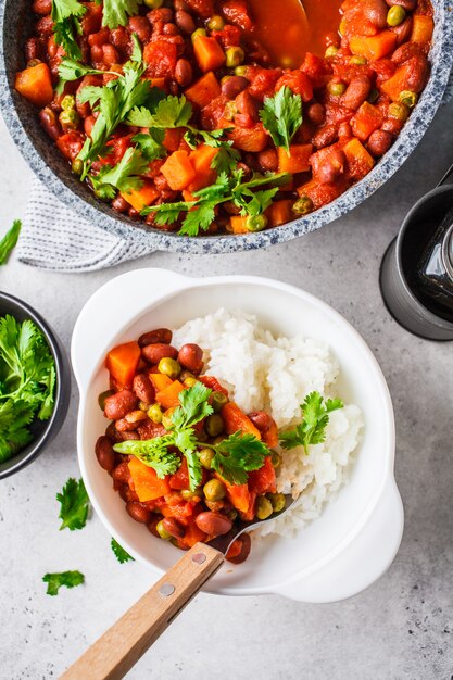 Vegan bean stew with tomatoes and rice in a pan 