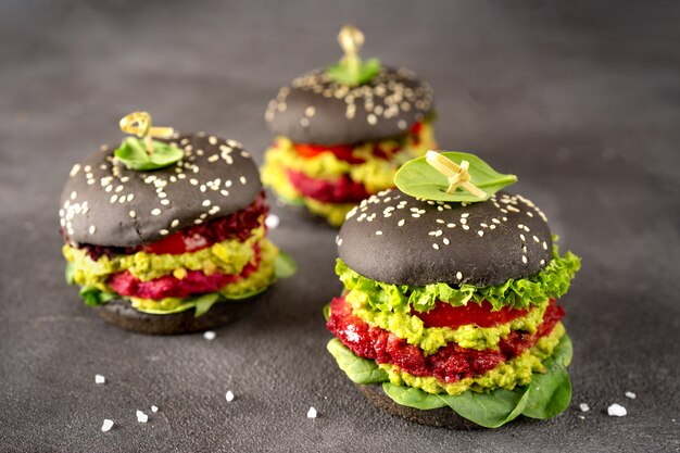 Vegan black burgers with beet patties on dark 