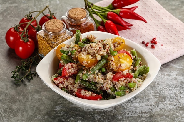 Vegan boiled quinoa with vegetables tomato and geen bean