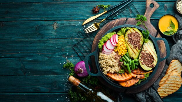 Vegan bowl quinoa avocado pumpkin with beans and corn in a black bowl Diet Top view Free space for text