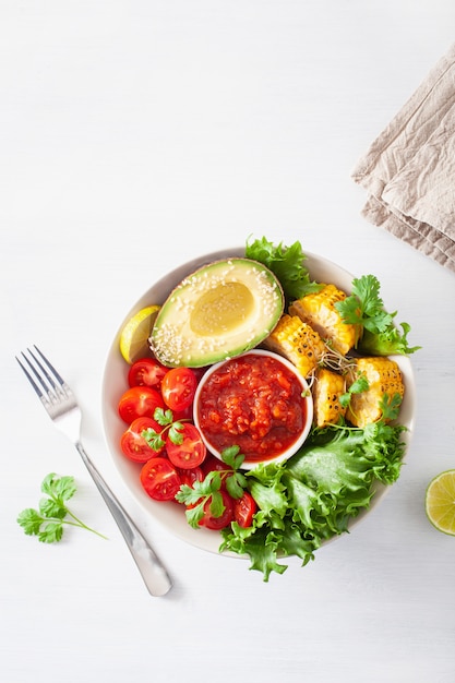 Vegan buddha bowl. healthy lunch bowl with avocado, tomato, sweet corn and salsa