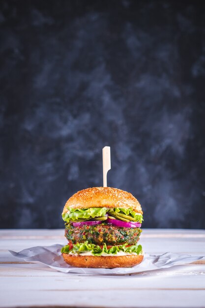 Vegan burger on a white table and a dark blue background