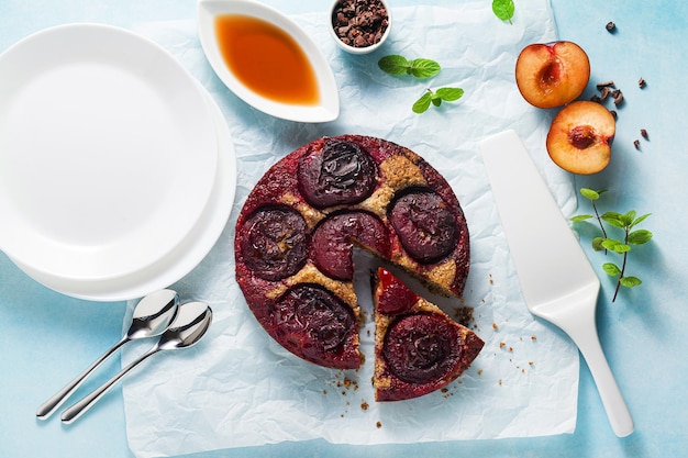 Vegan cake with fresh plums and maple syrup gluten free and refined sugar free paleo