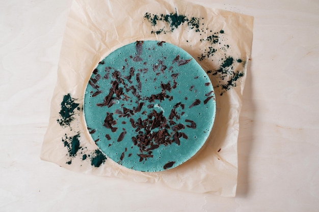 Vegan cake with spirulina Homemade baking Top view Delicious round tart with spirulina on the wooden table