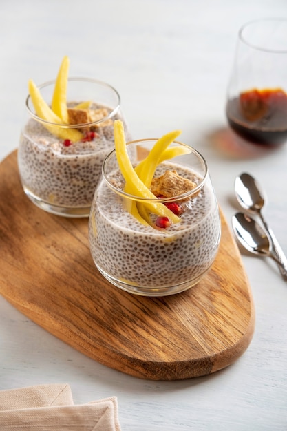 Vegan chia coconut pudding with mango on white background. Healthy nutrition, superfood. Closeup view.