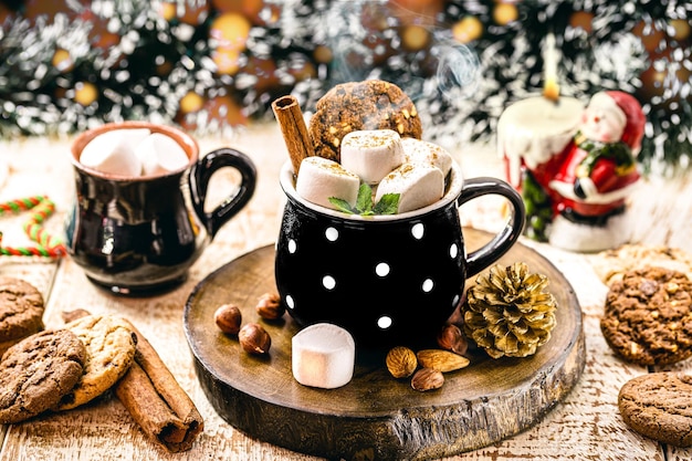 Photo vegan christmas hot chocolate with cinnamon, cream, marshmallow, mint and hazelnut. new year's hot drink.