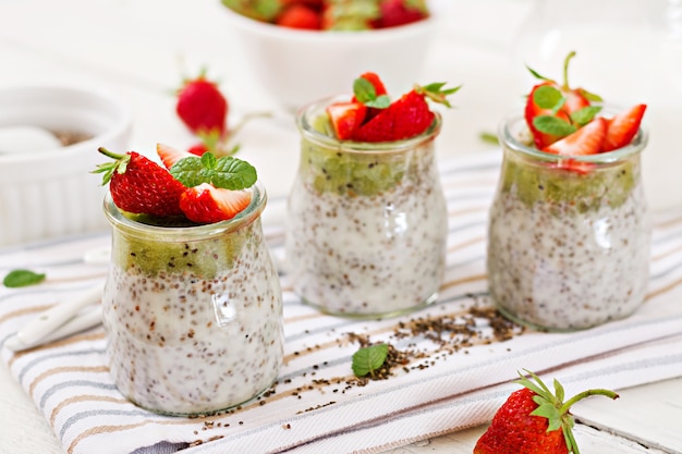 Vegan coconut milk chia seeds pudding with strawberries and kiwi.