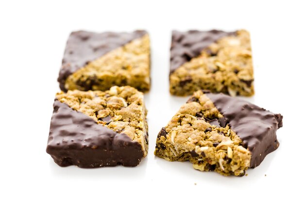 Vegan Cowgirl Squares dippen in chocolate on a white background.