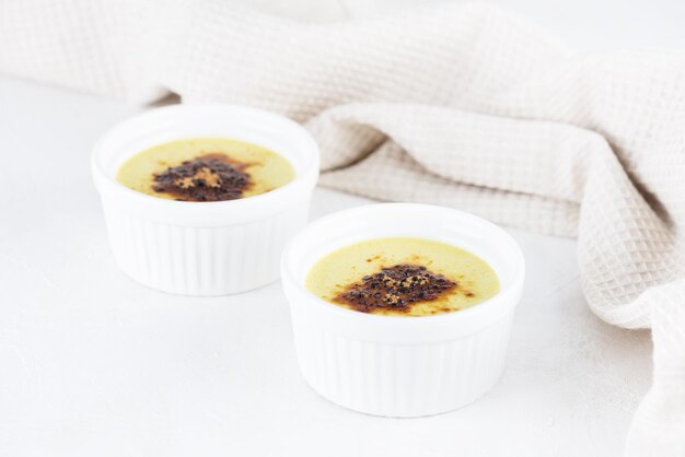 Vegan creme brulee with blueberries in bowls on the table.