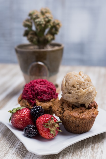 Vegan cupcakes with berries and ice cream