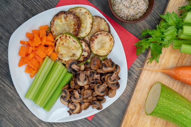 Vegan diet food. Fried mushrooms with celery, carrots and zucchini.