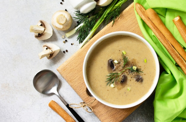 Vegan and diet healthy food Mushroom soup puree with cream champignons and vegetables Top view
