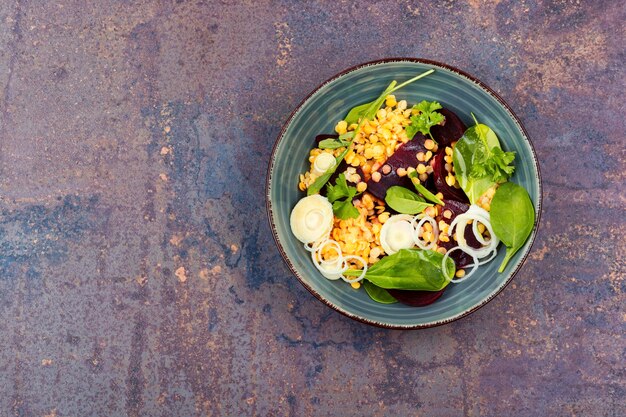 Vegan dietary salad with beets lentils onions and greens in the plate Top view space for text