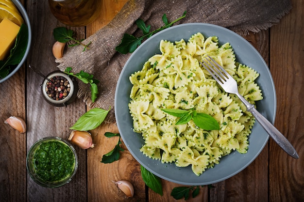 Vegan  Farfalle pasta in a basil-spinach sauce with garlic. Flat lay. Top view