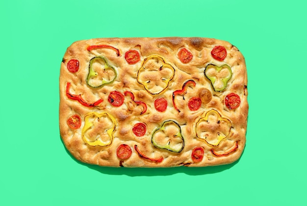 Vegan focaccia above view minimalist on a green background