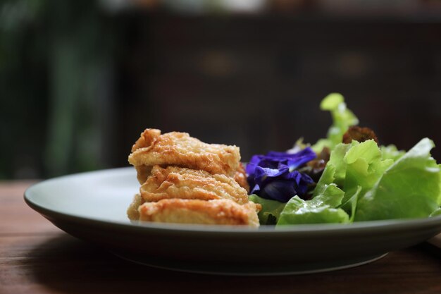 Vegan food appetizer japanese fried tofu on wood background vintage style