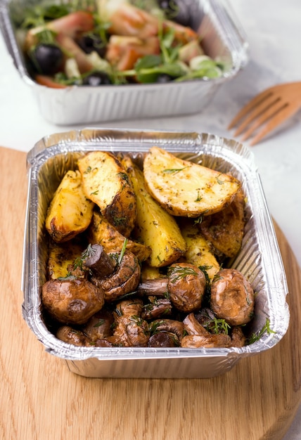 Vegan food delivery. Fried potatoes with mushrooms